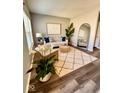 View of the staged living room featuring sleek wood floors and lots of natural light at 12461 Hawks Landing Dr, Fishers, IN 46037