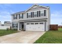 Charming two-story home with gray siding, black shutters, and a two-car garage at 13860 N Tiosa Ln, Camby, IN 46113