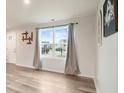 Inviting living area with wood-look floors and natural light from a large window at 13860 N Tiosa Ln, Camby, IN 46113