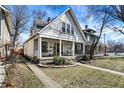Lovely two-story home featuring a classic front porch swing and seating, set on a well-manicured lawn at 139 S Ritter Ave, Indianapolis, IN 46219