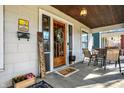 Inviting front porch with wood door, stylish seating, and decorative accents for a cozy outdoor space at 139 S Ritter Ave, Indianapolis, IN 46219