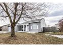 Charming single story home in winter setting with leafless tree in front at 163 Country Wood Dr, Whiteland, IN 46184