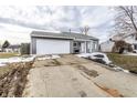 Attractive one-story home with a two-car garage on a cloudy day at 163 Country Wood Dr, Whiteland, IN 46184