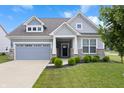 Charming single Gathering home with a well-maintained lawn and a two-car garage at 16401 Brigham Ln, Westfield, IN 46074