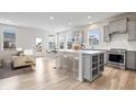 Bright, open kitchen with a large island, stainless steel appliances, and modern gray cabinetry at 16401 Brigham Ln, Westfield, IN 46074