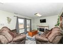 Comfortable living room with plush seating, fireplace, and lots of natural light at 22569 State Road 37 N, Noblesville, IN 46060