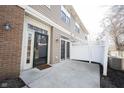 Private back patio area with neutral siding and a white decorative fence at 2332 Brightwell Pl, Indianapolis, IN 46260
