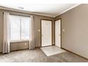 Inviting foyer features neutral carpet, a bright window, and convenient access to other rooms at 304 E 48Th St, Anderson, IN 46013
