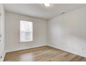 A clean bedroom with a large window and attractive wood-look flooring at 3224 N Capitol Nw Ave, Indianapolis, IN 46208