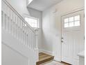 Bright entryway featuring freshly painted white trim and a wood-look accent stair at 3224 N Capitol Nw Ave, Indianapolis, IN 46208