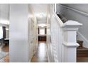 Hallway showcasing wood floors, white walls, and access to kitchen and stairs at 3224 N Capitol Nw Ave, Indianapolis, IN 46208