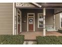 Inviting front porch with swing, decorative columns, and well-maintained landscaping at 37 N Main St, Indianapolis, IN 46227