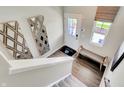 Bright entryway with wood-look floors, decorative mirrors, a window, and a view of the stairs at 3728 Sunset Ridge Dr, Franklin, IN 46131