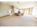 Spacious living room features high ceilings, neutral carpet, wood trim, and natural light at 4533 W 600 N, Fairland, IN 46126