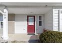 Close up of a red front door with sidelight, covered porch, and white siding at 459 Dekalb Dr, Westfield, IN 46074
