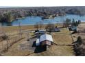 Scenic aerial view of a lakeside property featuring a home, large barn, and waterfront access at 5420 W Goeller W Rd, Columbus, IN 47201