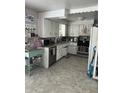 Bright kitchen with white cabinetry, stainless steel appliances, and coffee bar at 5700 S 100 W, Pendleton, IN 46064