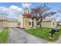 Eye-catching front exterior with stone chimney, tandem garage, and meticulously manicured front yard at 5762 Overcrest Dr, Indianapolis, IN 46237