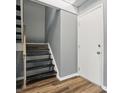 Basement entryway with wooden staircase, luxury vinyl plank flooring, and fresh paint at 5762 Overcrest Dr, Indianapolis, IN 46237