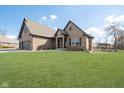 Beautiful brick home with an attached three-car garage, spacious lawn, and a charming gazebo at 6459 Canak Dr, Avon, IN 46123