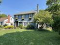 Charming two-story blue home featuring a well-manicured lawn and window box flower decorations at 722 Northview Ave, Indianapolis, IN 46220