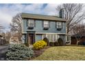 Two-story home with shutters on windows, brown front door, and shrubs and grass at 722 Northview Ave, Indianapolis, IN 46220