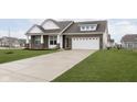 Attractive home with a brick and siding exterior, lush lawn, and spacious driveway at 1030 Macoun Dr, Westfield, IN 46074
