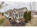 Home's exterior view featuring well-maintained landscaping, tan siding and multiple large windows at 10329 Gateway Dr, Indianapolis, IN 46234