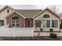 A single Gathering home showcases a mixture of brick and vinyl siding and a white picket fence at 10329 Gateway Dr, Indianapolis, IN 46234