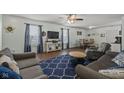 Cozy living room with lots of seating, hardwood floors, and a ceiling fan at 10613 Glenayr Dr, Camby, IN 46113
