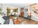 Open-concept living room showcasing hardwood floors, stylish decor, and a view of the adjacent dining area at 10867 Pine Bluff Dr, Fishers, IN 46037