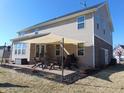 The home's backyard features a brick patio with a sunshade, string lights, and outdoor seating at 1211 Worcester Ct, Greenwood, IN 46143