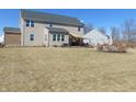 A wide shot of the home's backyard and patio with shade-cover at 1211 Worcester Ct, Greenwood, IN 46143