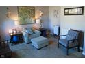 Comfortable seating area with a side table and decorative artwork at 1211 Worcester Ct, Greenwood, IN 46143