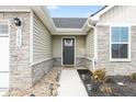 Close-up of the front entrance with stone accents, house number and landscaping at 1230 Maumee Ct, Greenfield, IN 46140