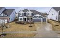 Beautiful two-story home featuring a three car garage, well-maintained lawn, and neighborhood pond at 12504 Castle Pine Dr, Noblesville, IN 46060
