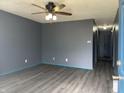 Open living room with sleek gray walls and modern gray wood-look flooring at 1280 Ash Ct, Martinsville, IN 46151