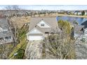 Aerial view of a beautiful home by the lake in a lovely neighborhood with mature trees at 1338 Valdosta Pl, Westfield, IN 46074