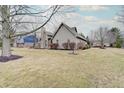 Beautiful one-story home featuring mature trees, green lawn and detailed siding at 16 W Greyhound Pass, Carmel, IN 46032