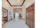 Bright foyer featuring tile flooring, wood trim, and views into the dining and living areas at 16 W Greyhound Pass, Carmel, IN 46032