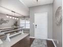 Bright dining area showcasing modern lighting, a stylish table with benches, and an accent wall decoration at 17215 Meggs St, Westfield, IN 46062