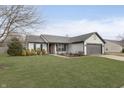 Charming one-story home featuring gray siding, a gray garage door, and a well-manicured lawn at 17215 Meggs St, Westfield, IN 46062