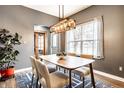 Dining area with modern decor, stylish lighting fixture, and a view of the front entry at 1941 Monticello Dr, Greenfield, IN 46140