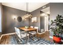 Dining area showcasing modern decor and lighting, complemented by the view into the hallway at 1941 Monticello Dr, Greenfield, IN 46140