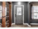 View of the home's entryway featuring a modern front door, attractive wood floors, and natural lighting at 1941 Monticello Dr, Greenfield, IN 46140