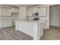 Modern kitchen featuring white cabinets, stainless steel appliances, and a center island at 1950 Black Oak Dr, Shelbyville, IN 46176
