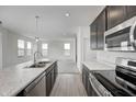 Modern kitchen with stainless steel appliances and marble countertops at 1951 Black Oak Dr, Shelbyville, IN 46176