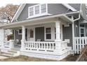 Attractive gray home featuring a covered front porch with decorative white columns at 21 S Warman Ave, Indianapolis, IN 46222