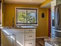 Bright kitchen featuring white cabinets, granite countertops, and a view of the outdoors through the window at 2333 Villa Ave, Indianapolis, IN 46203