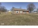 Picture of charming brick house from the side angle showing a large yard at 250 Three Notch Ln, Bargersville, IN 46106